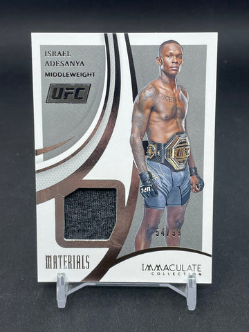 2021 PANINI IMMACULATE - MATERIALS - I. ADESANYA - #M-IAD - #'D/99 - RELIC