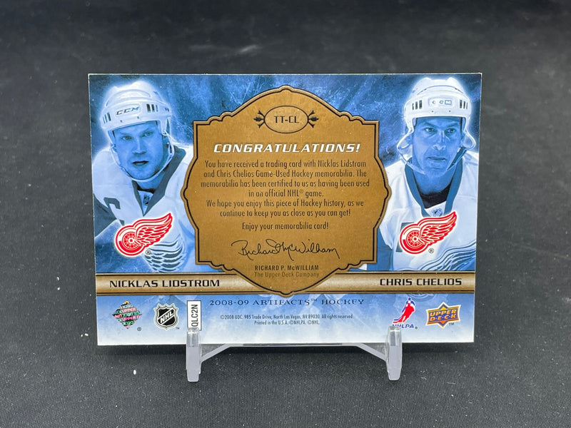 2008 UPPER DECK ARTIFACTS - TUNDRA TANDEMS - N. LIDSTROM / C. CHELIOS - #TT-CL - #'D/100 - DUAL RELIC